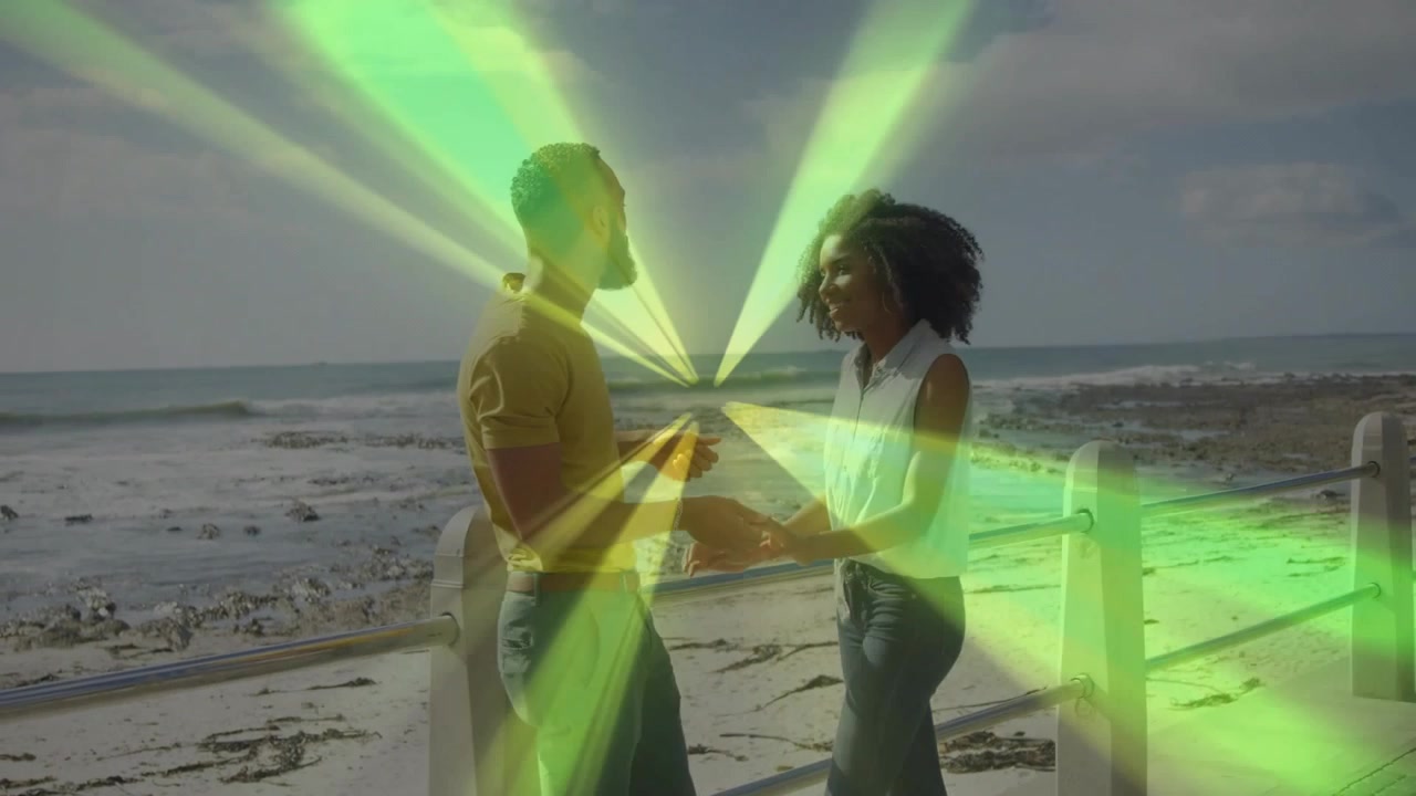 Man and woman talking and holding hands seaside, handhold sparking vivid light arcs for marketing