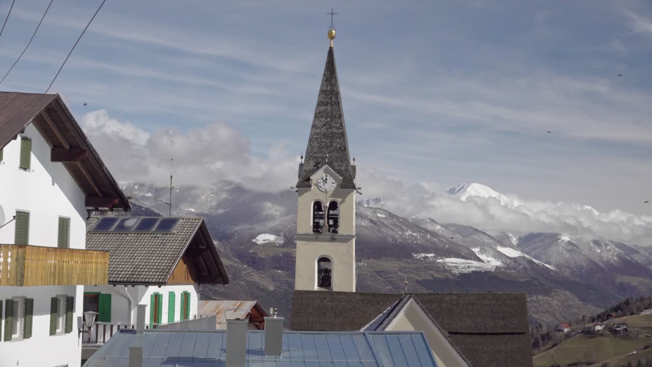 Picturesque Village View with Church Tower and Mountains