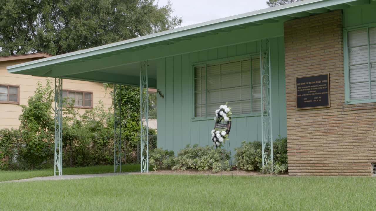 Close-up: Plaque and wreath. Civil rights leader Medgar Evers home. Site of his assassination. Jackson, Mississippi.