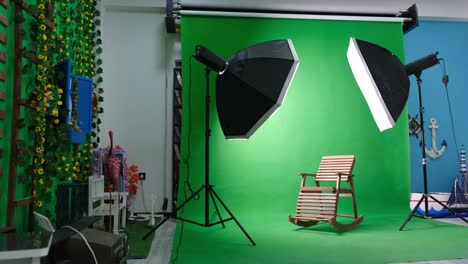 photo or video studio with two hexagone studio lights. green screen and fixed chair