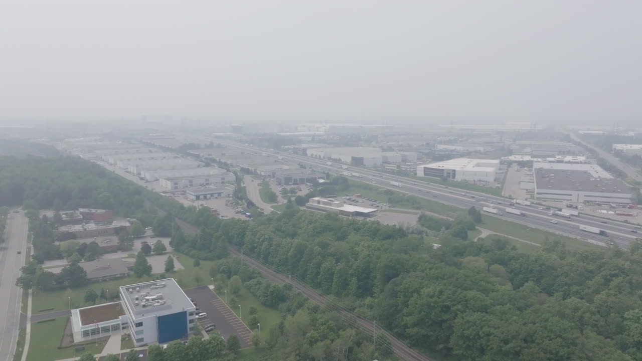 Mississauga with hazy sky and wildfire smoke affecting air quality, aerial view