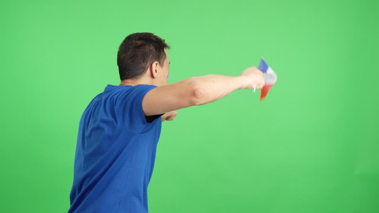 Rear view of a man waving a french pennant