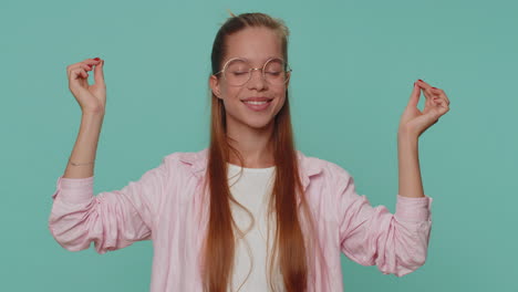 teen girl breathes deeply with mudra gesture, eyes closed, meditating with concentrated thoughts