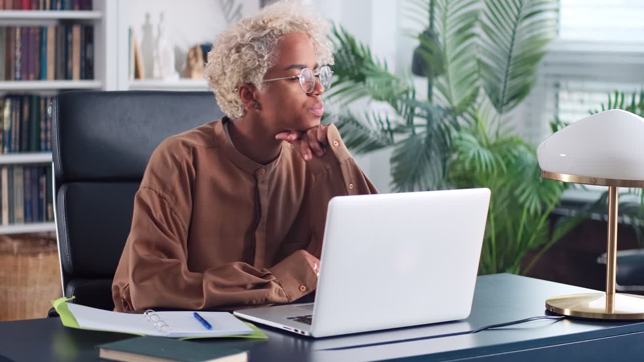 Young african american woman student typing text on laptop doing self education