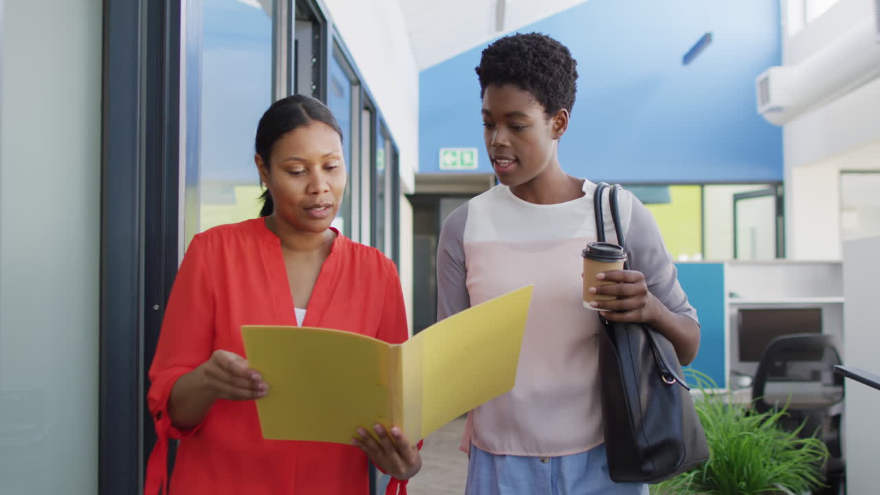 African american business people discussing work at office, slow motion