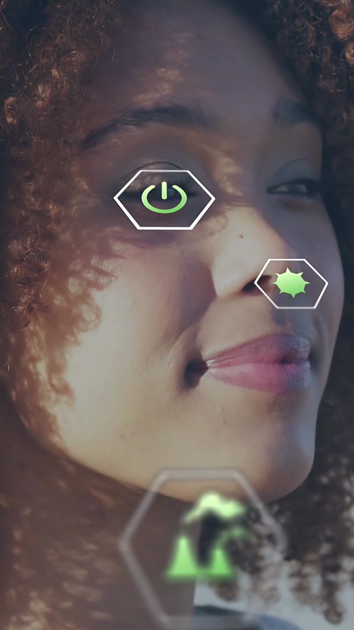 Vertical video: Woman blinking while AR detecting face and overlaying green hex power data