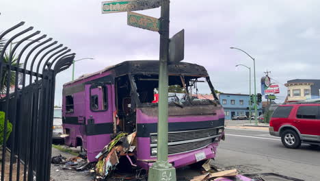 Burned-Abandoned-Vehicle-With-Garbage-In-The-Street-In-Oakland,-California