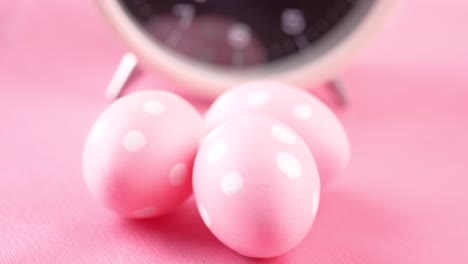 pink easter eggs with alarm clock