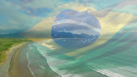 digital composition of waving brazil flag against aerial view of beach and sea waves