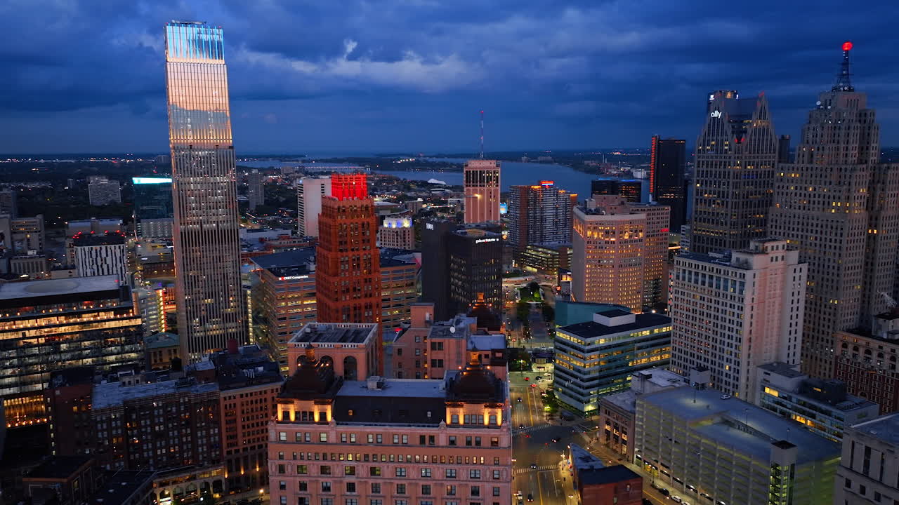 Detroit, USA, 28 July 2025: Moving over the tops of the high-rises in the downtown of Detroit, Michigan, USA. Grey clouds cover the sky over the city in the evening