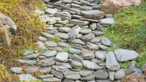 stone path leading up on the of green grass ancient river stone path. stone path leading up on the of green grass. ancient river stone path. remains of the ancient part of the building