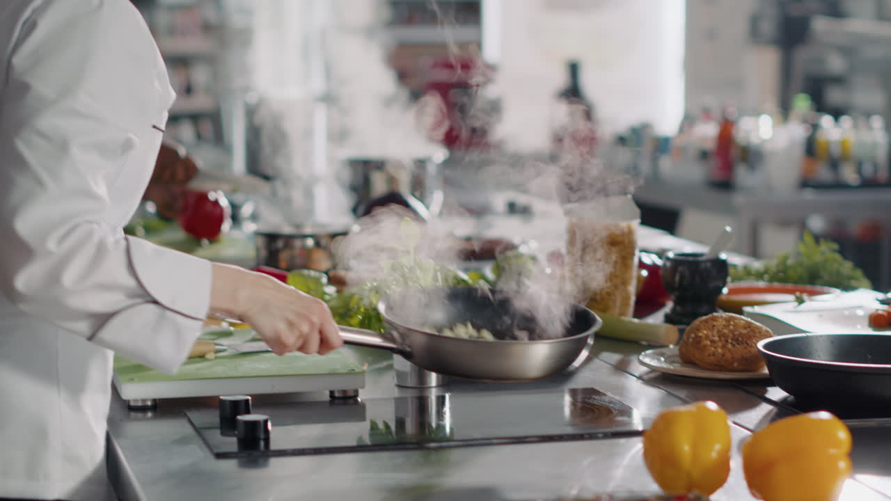 Professional cook preparing gastronomy dish in frying pan