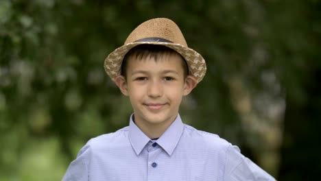 portrait of a farmer happy boy in the hat looks into the camera and smiles