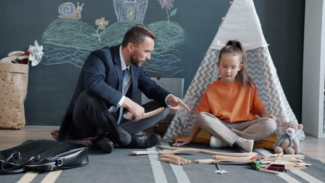 father and daughter playing with toys
