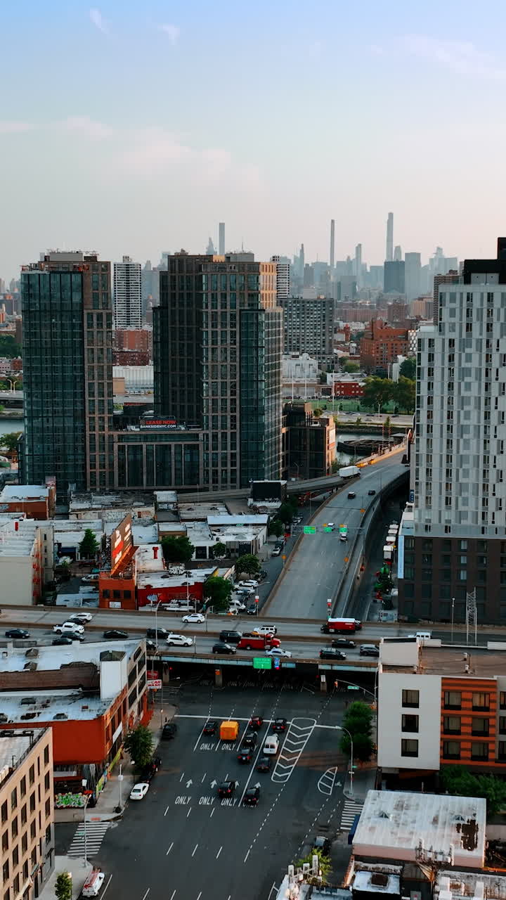 One of the areas in New York. Traffic on the roads among the modern beautiful buildings. Top view. Vertical video