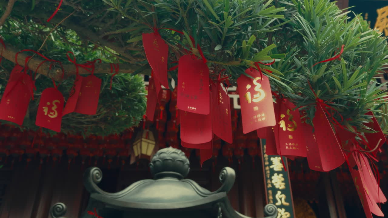 Red Tags of Wishes Hanging from a Tree in a Chinese Temple