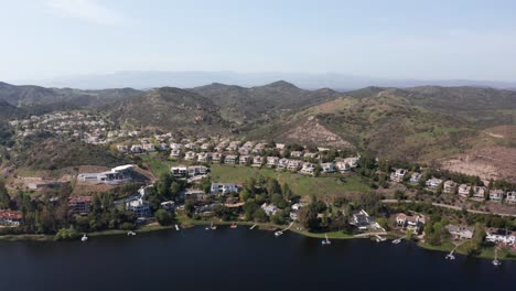 aerial wide push-in shot of luxurious waterfront homes in lake sherwood, california. 4k at 30 fps