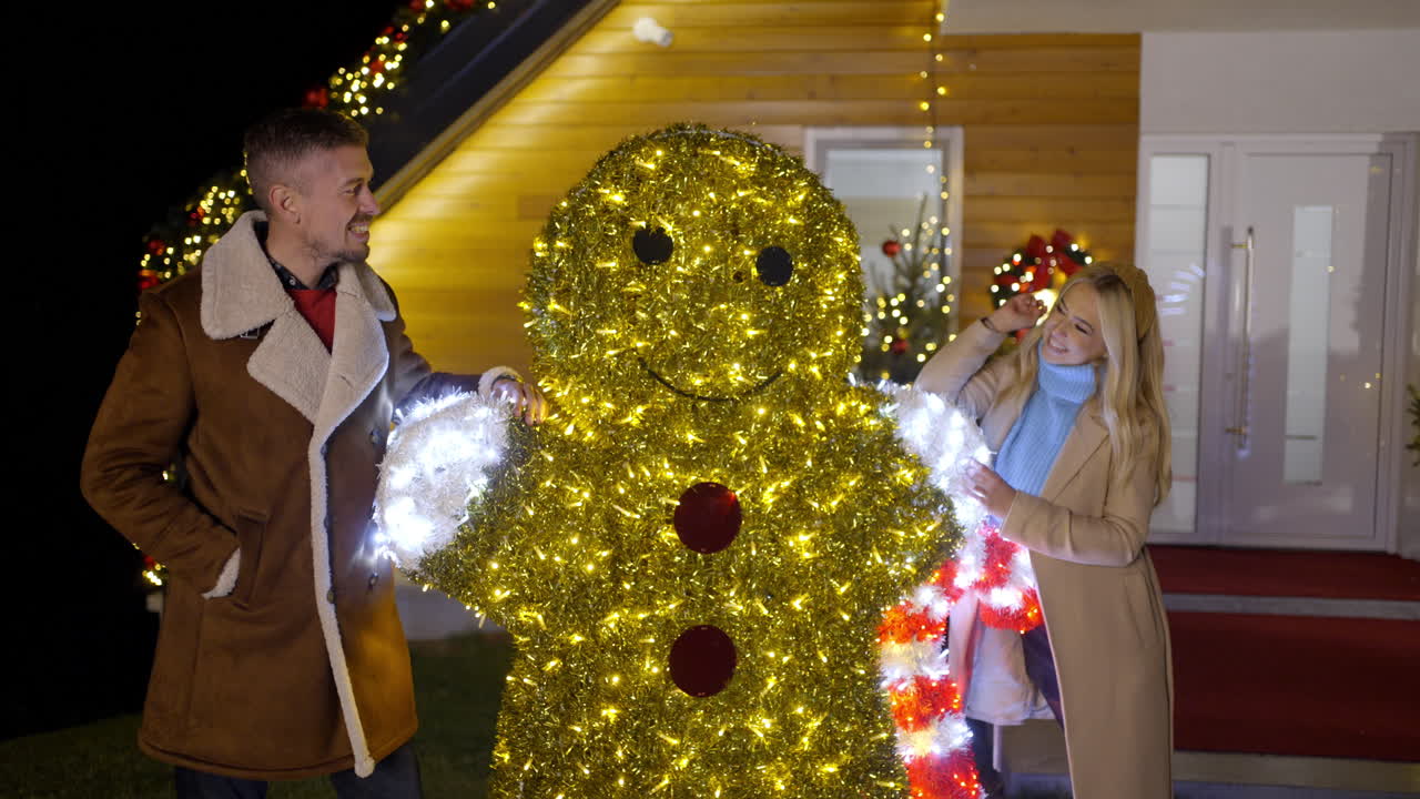 People posing with Christmas decorations