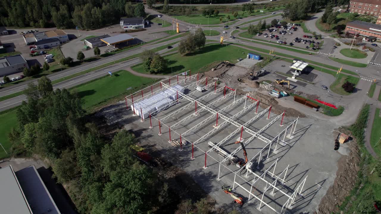 sitio de construcción con excavadora y grúa, órbita aérea en el país nórdico