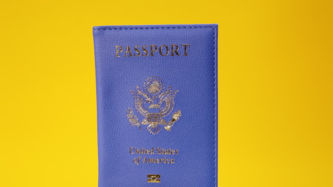 A blue passport, with the emblem and the text United States of America, on a rotating surface