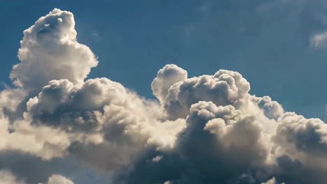 dynamic cumulus clouds forming in a dramatic blue sky