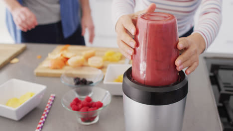 video of midsection of diverse couple preparing juice