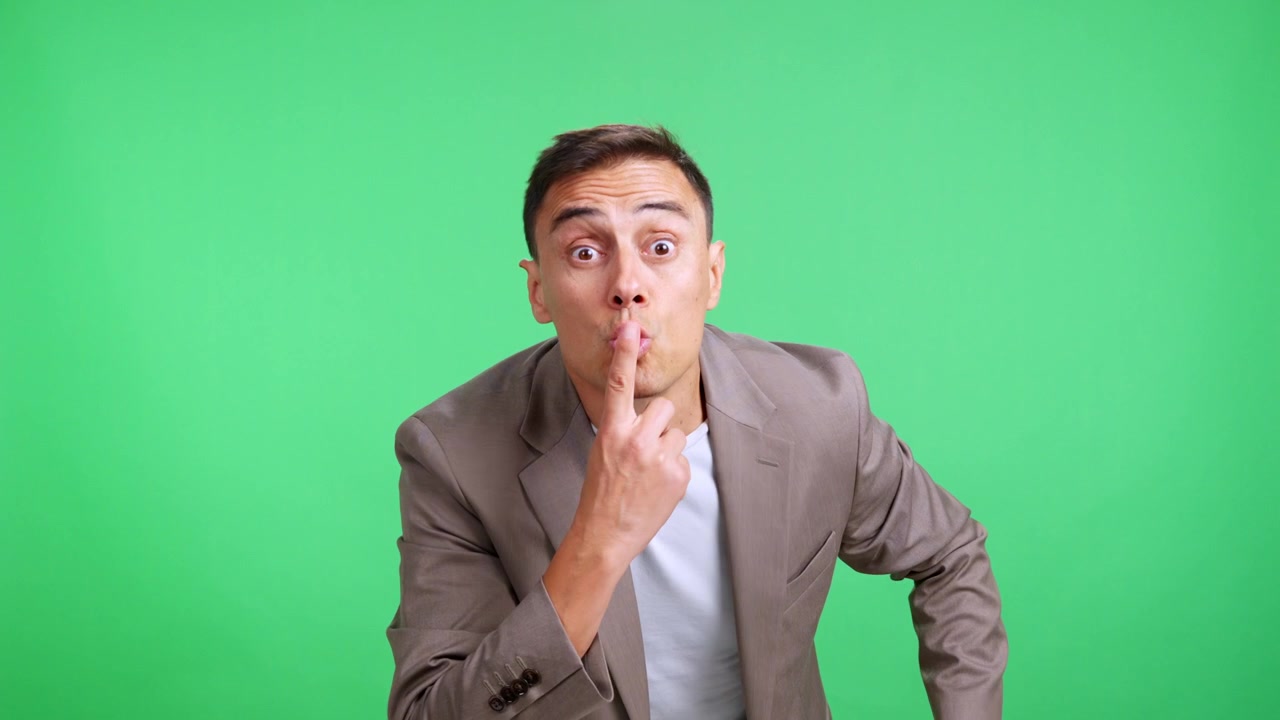 Businessman asking for silence with finger on lips