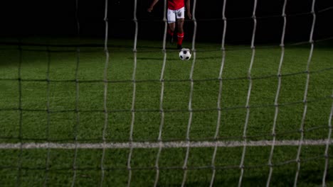 soccer player scoring a goal against open goal post 4k