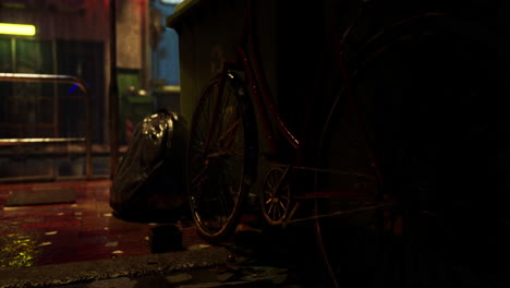 a rusty bicycle is parked next to a dumpster in a dark alleyway