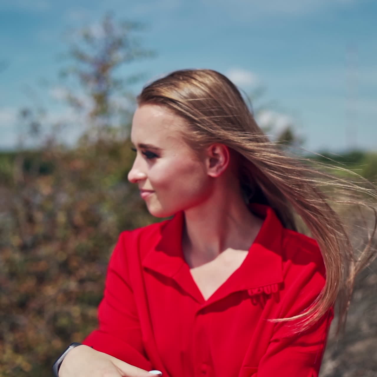 Portrait of young model in nature. Face of attractive woman posing to camera outdoors. Beautiful girl on blur natural background.