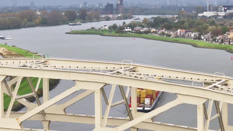 cargo vessel full of goods partially obstructed by bridge structure