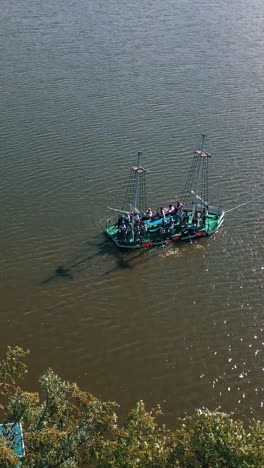 old boat floating in the river background. boat trip along the river. aerial view. camera moves down. vertical video
