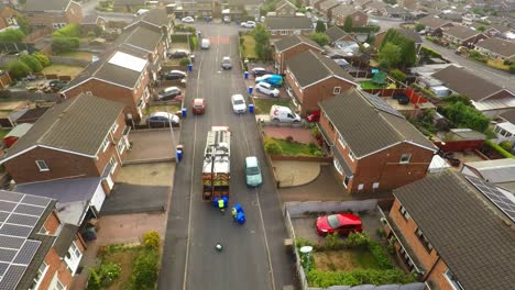 Aerial-View,-footage-of-Dustmen-putting-recycling-waste-into-a-garbage-truck,-Bin-men,-refuse-collectors