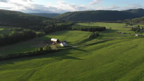 fly over drone footage overlooking farmhouse at restigouche, new brunswick, canada