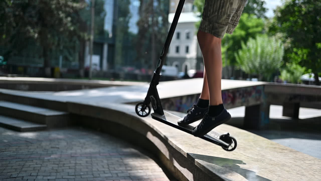 Boy jumping on a skateboard in a sport park, slow motion