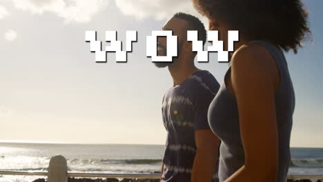 animation of wow text over african american couple at beach