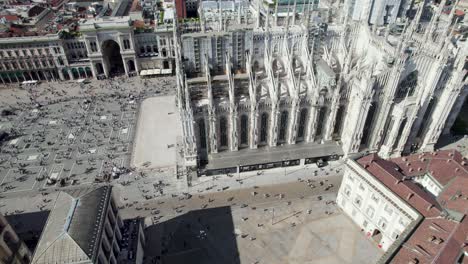 duomo cathedral and piazza duomo in milan, italy, aerial drone view, tilt up