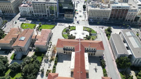 a drone captures athens, greece, flying over the university of athens, showcasing the building's rear and the road in front