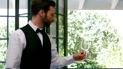 Waiter-examining-a-empty-wine-glass