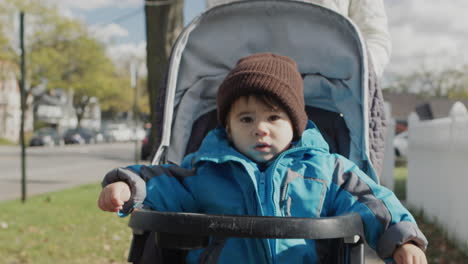 mom takes an asian baby in a woodpecker stroller