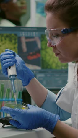 female scientist performing lab experiment with petri dish