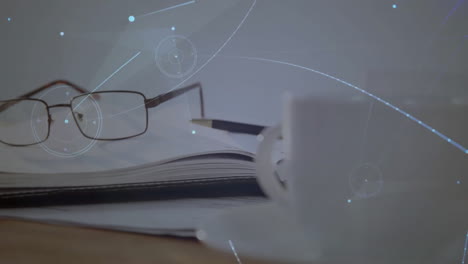 creative desk being animated in flat design, showing open notebook, pencil, glasses and coffee mug