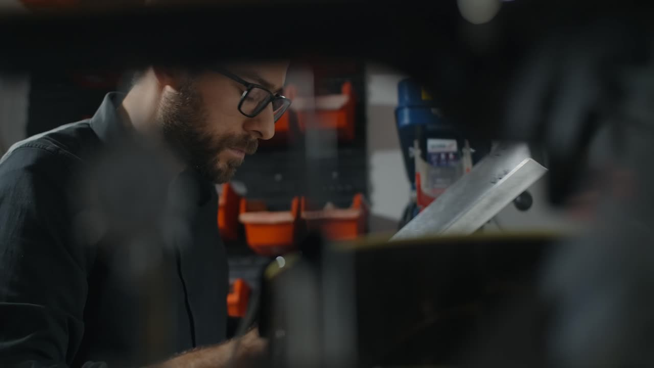 Man working on drilling machine in a workshop