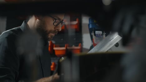 man working on drilling machine in a workshop