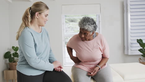 Fisioterapeuta-Femenina-Caucásica-Hablando-De-Una-Mujer-Mayor,-Espacio-Para-Copiar,-Cámara-Lenta