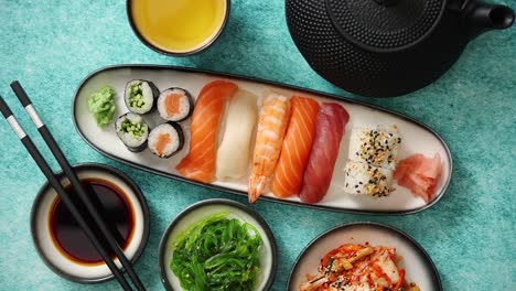 asian food assortment  various sushi rolls placed on ceramic plates