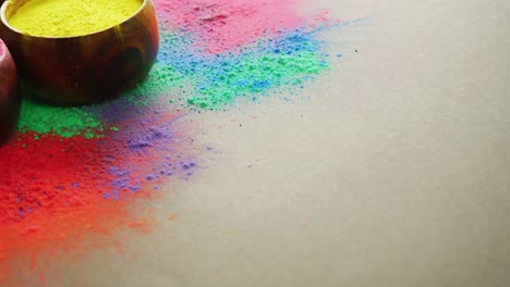 video of multi coloured powders and bowls with copy space on black background