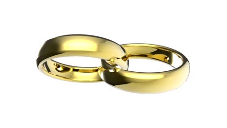 dos anillos de oro de bodas giran juntos sobre un fondo blanco.