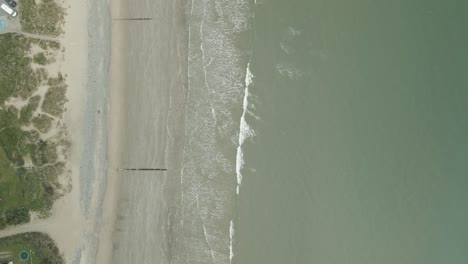 bird's eye view over rosslare beach and town in county wexford, ireland - drone shot