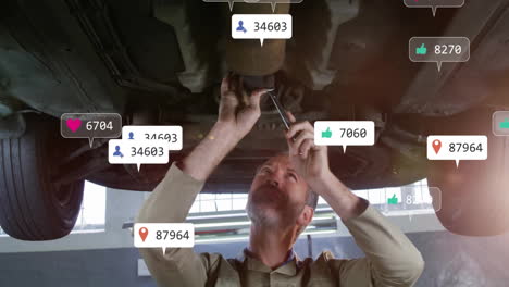 mechanic adjusting car undercarriage in auto workshop, showing floating likes and location icons